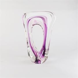 Jim Karg Art Glass Sculpture: A Jim Karg studio art glass sculpture, dated 1998. This flared O-shaped glass sculpture features a clear glass design with a violet accents. Etched signed “Jim Karg, 1998” along the base.