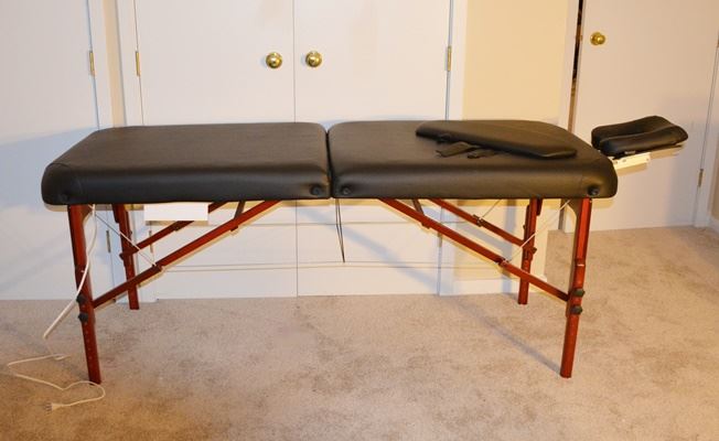 The Stafford Folding Massage Table: A Stafford thermal folding massage table by Chicago Master Table. Designed with a black Therma-Top surface, with a built in heating pad system, the portable table includes a folding frame. A head rest is also included.