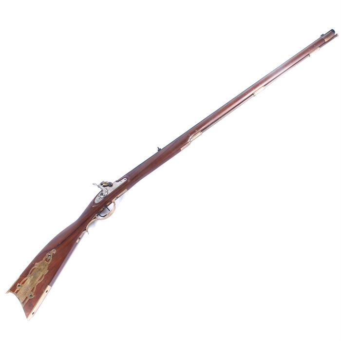 Pedersoli Black Powder .38 Cal Rifle: A reproduction 1836 Texas “Alamo Long Rifle”. The .38 caliber black powder rifle has a wood stock, accented with brass, and an octagonal steel barrel. The stock has a decorative etched brass plate with a Texas seal, an image of the Alamo, and the date 1836. The plate near the hammer is also engraved with “1836” and a five-pointed star. The barrel is marked “Pedersoli – Black Powder Only – Made in Italy – Cal. 38”, with serial number 26166. The rod is wood with brass tips.