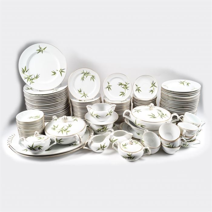 Large Set of Japanese Narumi China Dinnerware: A 163-piece set of Japanese vintage Narumi China dinnerware. The service features white porcelain decorated with light and dark green bamboo, accented with gold luster. The set includes two lidded dishes, two creamer pitchers, two sugar bowls, two gravy boats, two small oval serving dishes, an oval bowl, twenty-four dinner plates, twenty-four bread plates, twenty-three salad plates, twenty-three soup bowls, eighteen small bowls, fourteen teacups, and twenty-four saucers. The set is marked “Narumi China – Japan”.