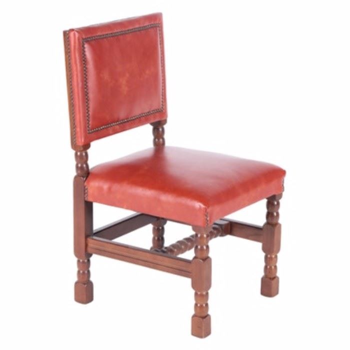 Jacobean Style Chair by Empire State Chair Company: A Jacobean style chair by the Empire State Chair Company. This reddish orange “faux” leather chair features a squared backrest with brass nail head trim over a padded square seat. It stands on thick bobbin turned legs with a “U” stretcher support including a turned central stretcher.