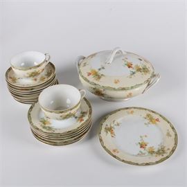 Empress "Woodmere" Porcelain: A nineteen piece collection of Empress porcelain. This group includes a salad plate, dessert plates, tea cup and saucers and round vegetable serving dish with lid. This pattern _Woodmere _ is composed with green edges and floral band. Items are marked to the bottom Empress China Japan.