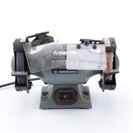 Delta Bench Grinder: A 5" Delta bench grinder, model 23-580, with a single phase 1/5 hp engine, 3,450 rpm operating speed, flip-down guards and dual wheel attachments.
