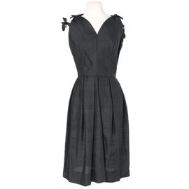 Seymour Paisin Occasion Dress: An occasion dress by Seymour Paisin. This black dress features a sweetheart style neckline, bow accents to the shoulders and a low v backing. It fastens with a back zip and appears to be comprised of raw silk. The dress is marked with an interior brand label.