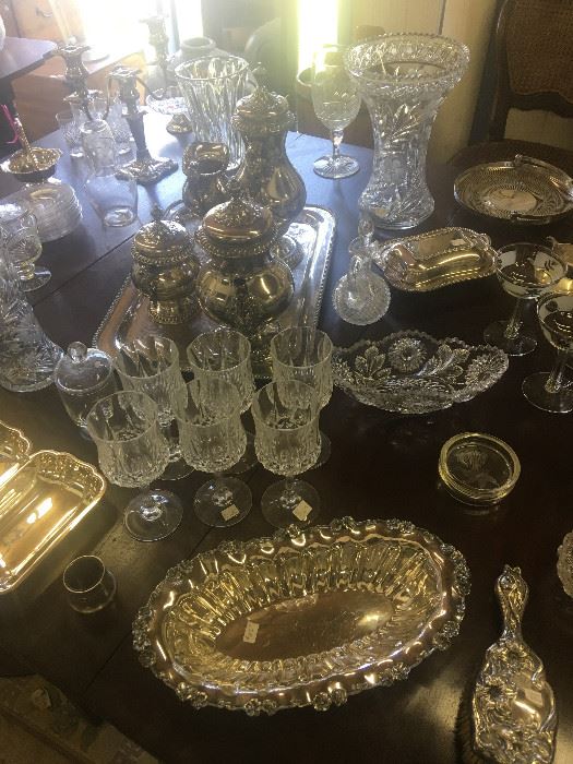 Table full of 19th and early 20th century glass and silver plate.