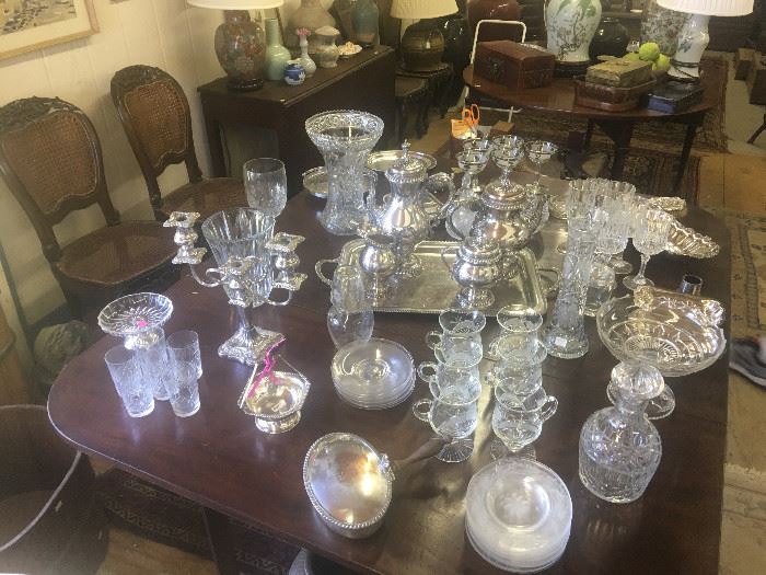 American drop leaf dining table covered in 29th and early 20th century American and British glass tablewares, silverplate, etc.