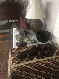 Native American rug, carvings, and vase lamp made from pottery.