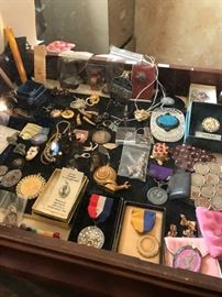 Belt Buckles, Snail Tape Measure, Military Ribbons, Dog Tags, Collectible Jewelry coins, kaleidoscope. 