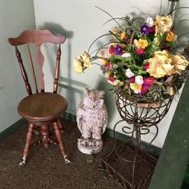 Antique piano stool with ball feet, owl statue, and iron plant stand. 