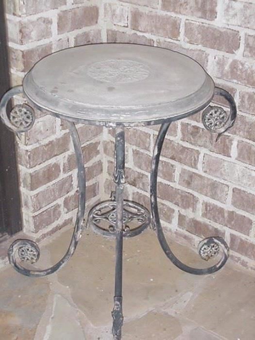 Two stone top wrought iron tables
