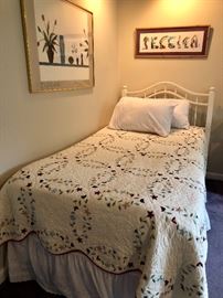 Twin bed, wall art and linens