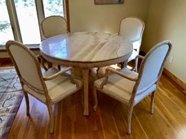 Marble top table, carved wood bottom with 4 wood and upholstered chairs. By Buying and Design