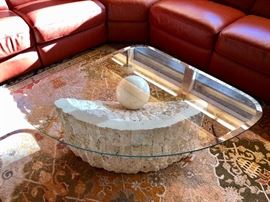 Abstract, unusual glass-top table with plaster/marble (?) base