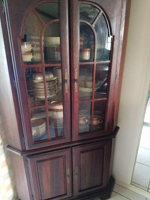 Dining hutch with dishes.