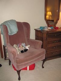 one of two pink wing=back chairs