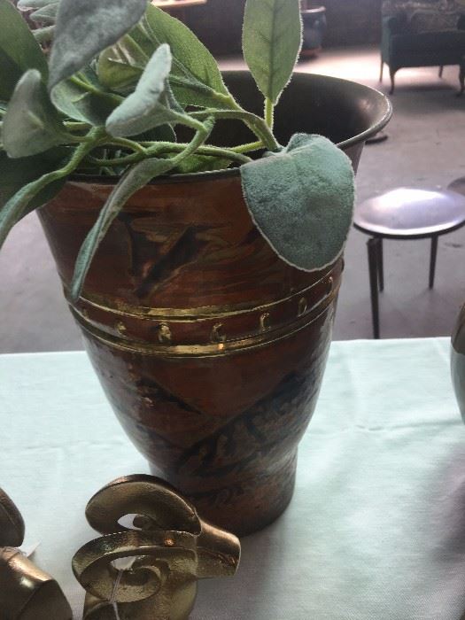 Metal vase with design. 