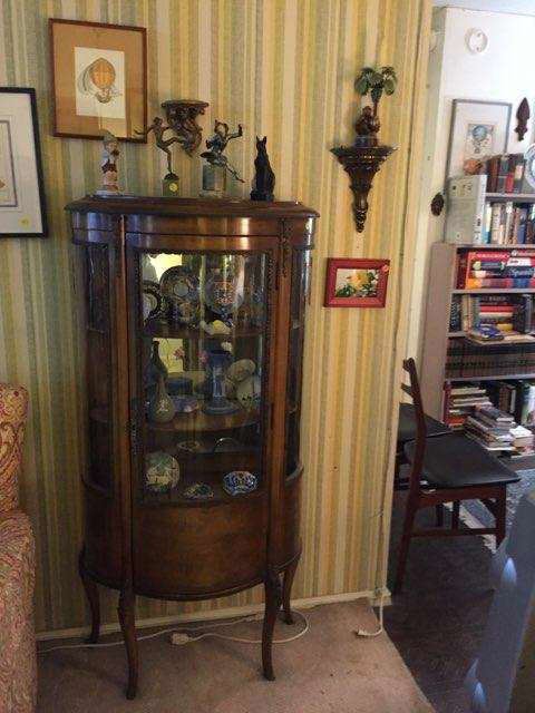 Curved glass Curio cabinet.