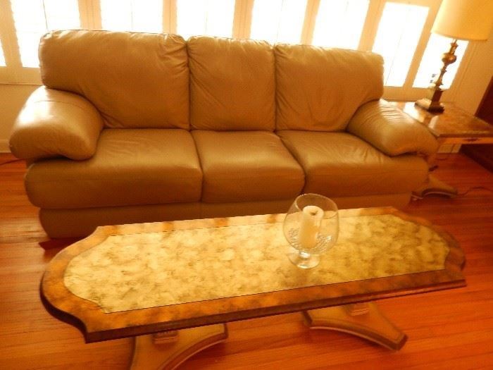 Leather sofa in very good condition and Hollywood Regency coffee table.