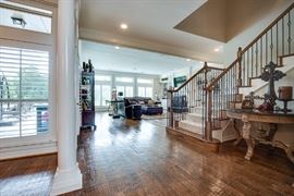 Round table next to the stairs. 48 inches in diameter, granite top, goes beautifully with the buffet and mirror.
