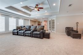 4 Black Leather Reclining Movie Chairs with two side storage ottomans.