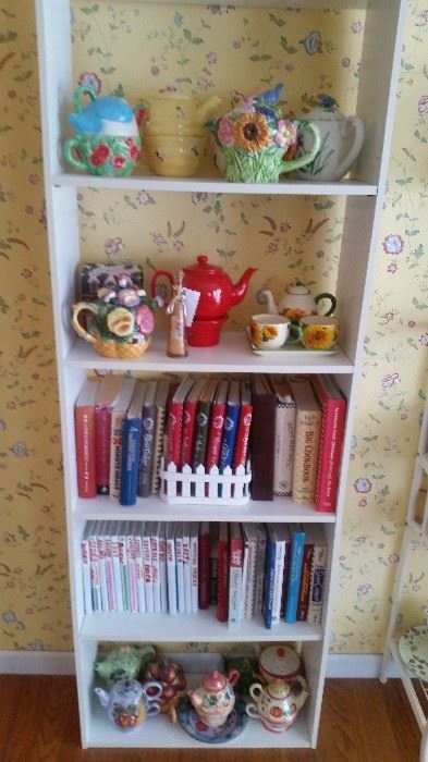 PART OF TEA POT COLLECTION AND WHITE SHELF SOME COOK BOOKS