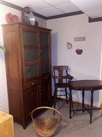Bakers Cabinet  -  Antique high chair  -  Antique table  -  Old basket - Old lantern  -  Wall décor   