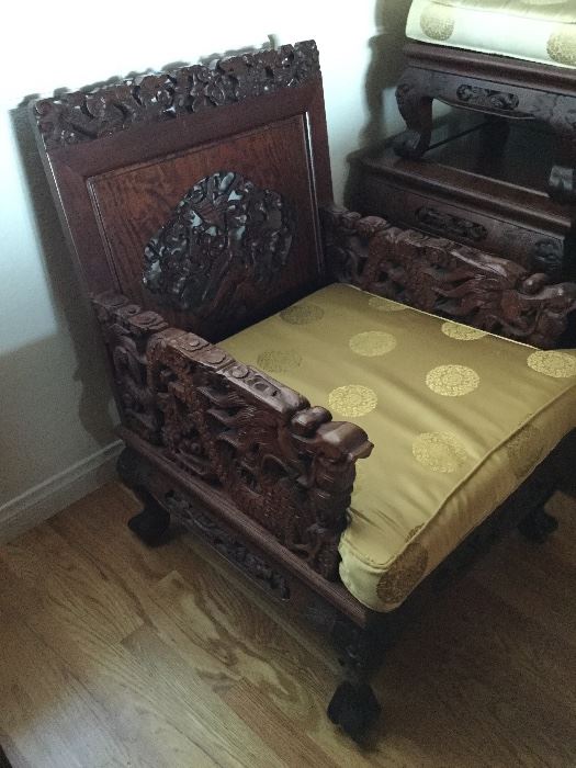 Two side chairs with dragon arms, each has seat and back cushions, just removed to show carvings