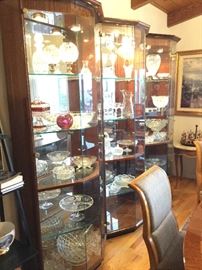 One view of three display cabinets by Henredon that match the dining set, each lighted with side glass door openings