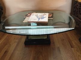Coffee table of glass arched supports under glass beveled top slight chips on underside