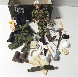 1964 G.I Joe Doll with Accessories and Metal Locker: A lot of vintage G.I. Joe collectibles. The lot includes a 1964 talking G.I. Joe 11" action figure, several shirt and pant outfits, boots, dog tags, and many small accessories. Included is a green metal foot locker that houses all items.