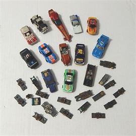 Slot Car and Slots Collection: A collection of slot cars and parts. The lot consists of thirteen vintage slot cars and car shells, in various styles and colors, with additional seventeen slots.