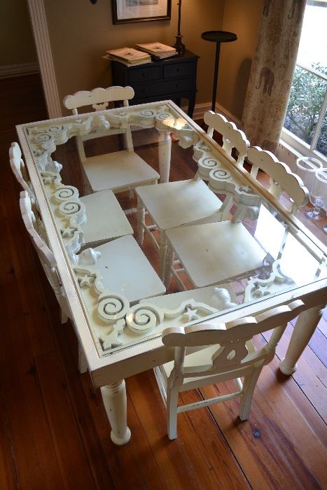 Really unique glass top dinning table with 6 chairs.
