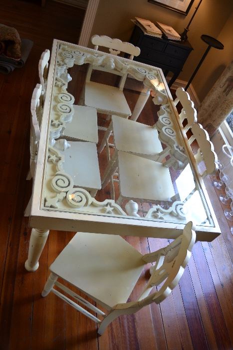 Really unique glass top dinning table with 6 chairs.