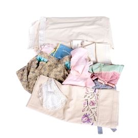 Vintage Kitchen Linens: A selection of kitchen linens. This group includes a table cloth, apron napkins, and doilies. The doilies are hand crocheted.