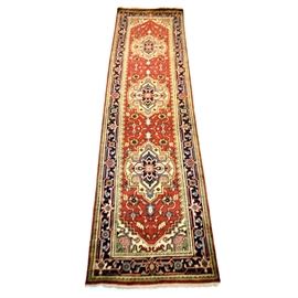 Hand-Knotted Indo-Persian Bakhshayesh Wool Runner Rug: A hand-knotted Indo-Persian Bakhshayesh wool runner. The runner features a series of three medallions worked in shades of Delft blue, ivory, dusty rose, sage green, and wine on a madder red field. The field is infilled with stylized geometric flowers and vines worked in the same palette. The spandrels have ivory grounds and the designs are incorporated into the crenellated inner border. There are two narrow guard borders with small linked floral motifs, flanking a primary border in blue with a turtle pattern. Short natural fringe to each end. Unmarked. Blue threads visible on back.