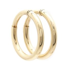 14K Yellow Gold Clip On Hoop Earrings: A pair of 14K yellow gold clip on hoop earrings. This item features hoop style earrings with spring loaded sliding closures.