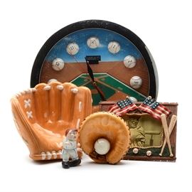Baseball Wall Clock with Ceramic Gloves: A group of baseball decorative items. The wall face is the inside of a baseball stadium. The clock’s numbers are on half baseballs which are affixed to the clock’s face. The frame is a silver tone metal; it’s a quartz clock that requires one AA battery (not included). There are two ceramic gloves, a catcher’s mitt with a baseball and a fielders glove. There’s a baseball theme resin frame and a small ceramic baseball figure marked, “Japan”.