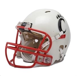 2010 University Of Cincinnati Allstate Sugar Bowl Game Helmet: A 2010 University Of Cincinnati team issued full-size football helmet. This collegiate football helmet has a white background with two side UC team applied team logo decals. With a red facemask from and Riddell white chinstrap, there are two “Cats and Cincinnati” team logos attached to the front and backside. There are three applied decals on the back of this helmet that include “American Flag, All-State Sugar Bowl, and Big East.” Appears that this helmet was issued for a lineman. The inside of the helmet has white ditted padding that exhibits little or no wear. The Bearcats lost to the Florida Gators led by All-American Tim Tebow and Urban Meyers in the 2010 Sugar Bowl.