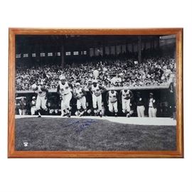 Pete Rose "First Game" Signed Photo Print PSA COA: An oversized black and white signed Pete Rose “First Game” framed photo print. Pete signed this photo print in blue marker and added the inscription “First Game 4-8-63” below his signature. This classic image depicts Pete leaving the Reds dugout to play defensively on the field at historic Crosley Field. The autograph is bold and smudge free and has been professionally authenticated by PSA with a hologram sticker and certification card attached in the lower left-hand corner. This display is presented in a brown colored wood frame underneath plexiglass. The backside has protective paper cardboard backing with a metal wire for mounting purposes. Pete is Major League Baseball’s “All-Time Hit King.” He is a member of the Cincinnati Reds Hall Of Fame.