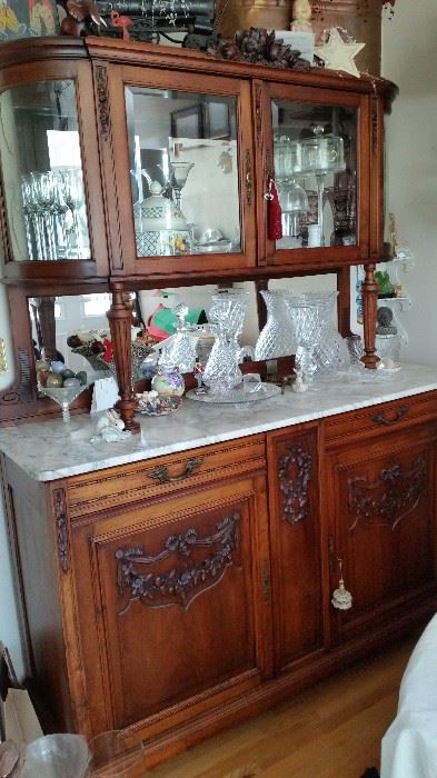 Antique carved french breakfront. Marble top, curved, beveled glass doors, mirrored back. Picture does not do it justice. $2,500