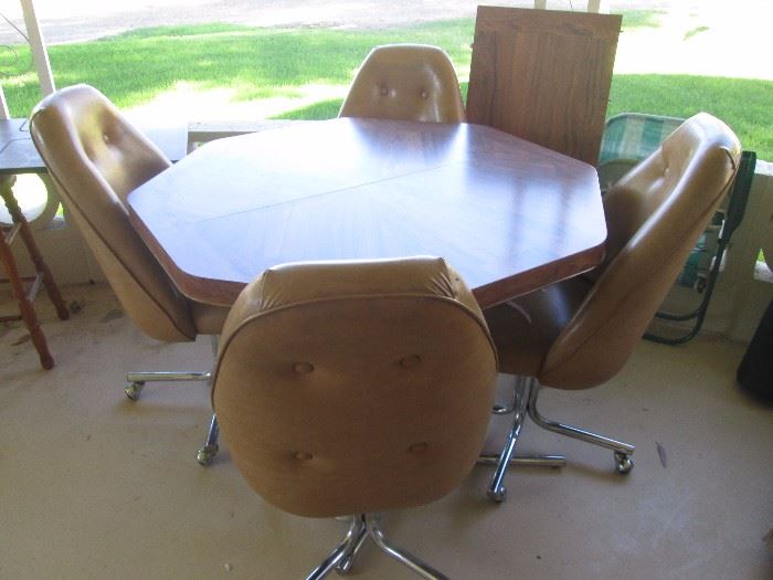 Octagon-shape dinette table/4 chairs, on chrome base with casters.  One leaf