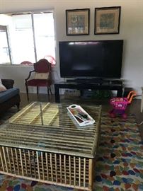 Glass top rattan trap style coffee table, Company C rug, Sharp TV 52"? Chair not for sale