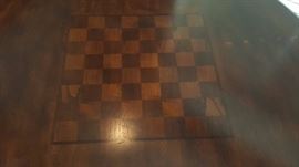 pub height table features a checkboard/chess top and comes with 4 stools