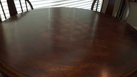 pub height table features a checkboard/chess top and comes with 4 stools