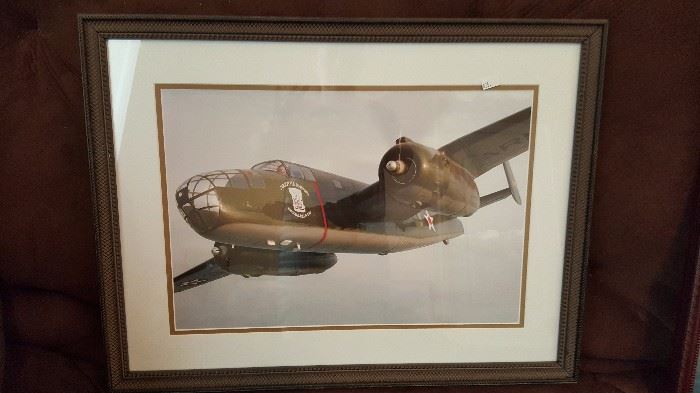 Framed photographs of reconditioned WWII bomber planes
