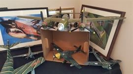 Framed photographs of reconditioned WWII bomber planes and model airplanes