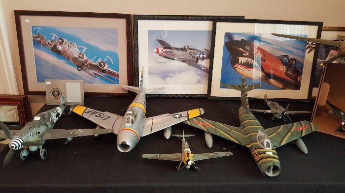 Framed photographs of reconditioned WWII bomber planes and model airplanes