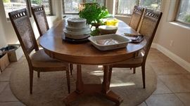 stunning light colored dining table has birds eye maple trim, two leaves and 6 chairs
