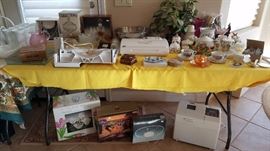 hummingbird collection, teacups, food saver, meat slicer, stainless steel mixing bowl set, and more - be sure to look under the tables too....lots to see, new in boxes! 
