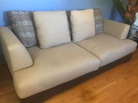 Neutral colored sofa (there are two matching ottomans that are not pictured)